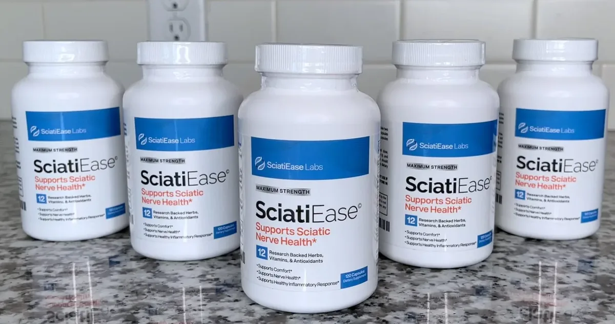 Five white SciatiEase bottles lined up on a granite kitchen counter